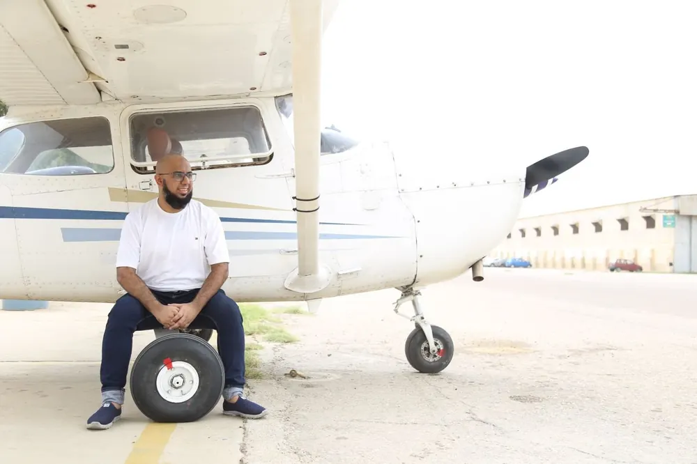 Muhammad Ahsan beside a light aircraft